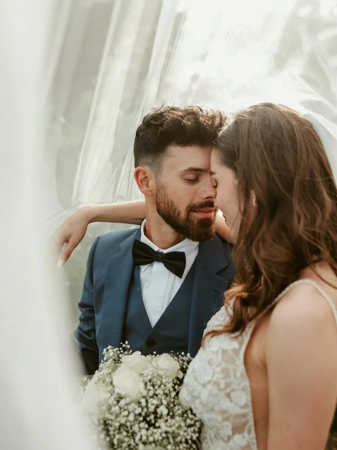 Original photo: bride and groom under a veil